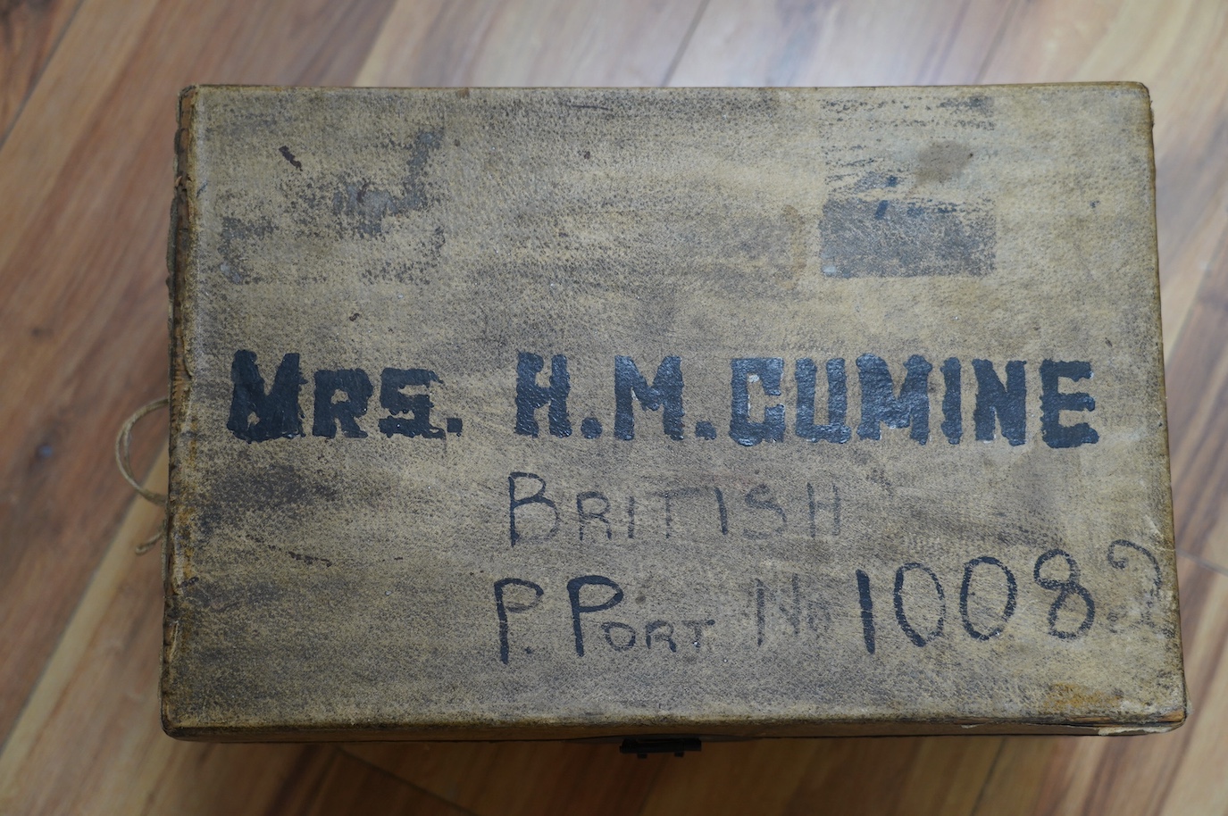 A vellum bound trunk, Chinese label to interior, 42cm wide, 24.5cm high. Condition - poor